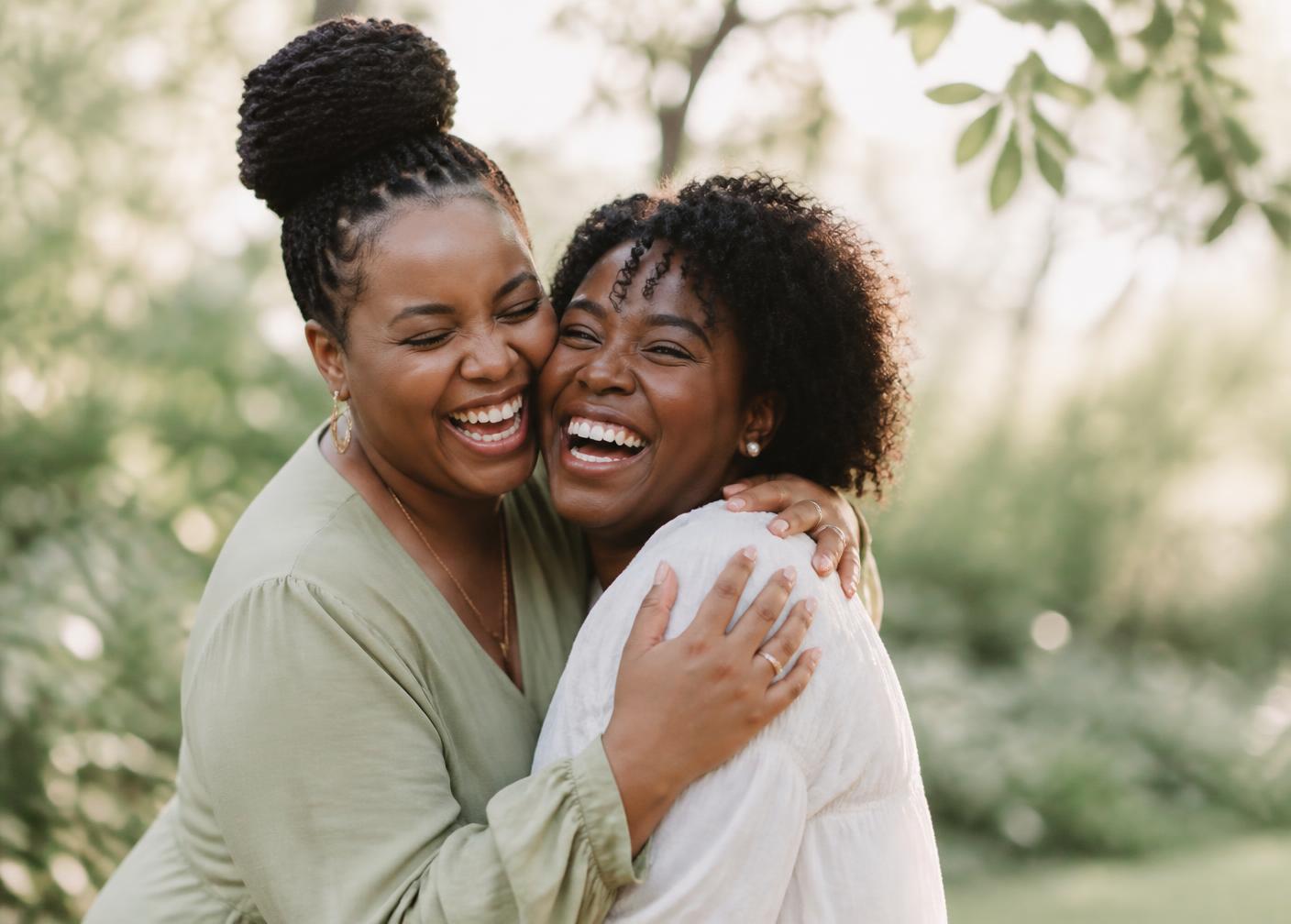 Two women embracing and laughing together